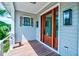 Covered porch featuring wood flooring, glass doors, a charming window, and modern lighting at 2870 Ion Ave, Sullivans Island, SC 29482