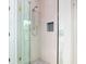 Walk in shower featuring light brown tile, chrome shower head, and a recessed shelf at 2870 Ion Ave, Sullivans Island, SC 29482