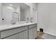 Bright bathroom with double vanity, quartz countertops, framed mirror, and tiled floor at 292 Shadybrook Dr, Summerville, SC 29486