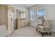 Bedroom with a dresser, ornate mirror, area rug, and chair underneath a set of windows at 292 Shadybrook Dr, Summerville, SC 29486