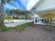 Community pool and lounge area surrounded by lush landscaping, picnic tables, and a covered structure for shaded seating at 292 Shadybrook Dr, Summerville, SC 29486