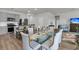 Open-concept dining area with glass table, gray chairs, gray cabinets, and stainless steel appliances at 292 Shadybrook Dr, Summerville, SC 29486