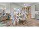 Elegant dining room featuring a glass-top table, upholstered chairs, and a stylish china cabinet with hardwood floors at 292 Shadybrook Dr, Summerville, SC 29486
