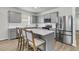 Modern kitchen with a center island, stainless steel appliances, and stylish gray cabinetry at 292 Shadybrook Dr, Summerville, SC 29486