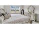 Well-lit main bedroom features a tufted headboard, detailed bedside tables, with a neutral color palette at 292 Shadybrook Dr, Summerville, SC 29486