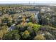 Aerial view of a home with a river in the background, mature landscaping and the surrounding neighborhood at 317 Seewee Cir, Mount Pleasant, SC 29464