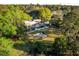 Aerial view of a modern home with a pool, fire pit, and mature trees surrounding the large yard at 317 Seewee Cir, Mount Pleasant, SC 29464