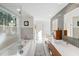 Stylish bathroom featuring double sinks, a soaking tub, and a walk-in shower with glass door at 317 Seewee Cir, Mount Pleasant, SC 29464