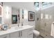Bright bathroom features a modern vanity, walk-in shower with glass door, and a view through clerestory window at 317 Seewee Cir, Mount Pleasant, SC 29464