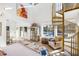 Bright primary bedroom features a spiral staircase and large windows overlooking the property at 317 Seewee Cir, Mount Pleasant, SC 29464