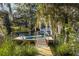 View of a private dock on the water with a kayak and boat, surrounded by trees and Spanish moss at 317 Seewee Cir, Mount Pleasant, SC 29464