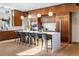 Modern kitchen with wood cabinets, quartz island, stainless appliances, and barstool seating at 317 Seewee Cir, Mount Pleasant, SC 29464