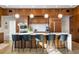 Modern kitchen with wood cabinets, quartz island, stainless appliances, and modern pendant lights at 317 Seewee Cir, Mount Pleasant, SC 29464