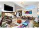 Bright, open-concept living area features a modern fireplace, hardwood floors, and expansive windows for natural light at 317 Seewee Cir, Mount Pleasant, SC 29464