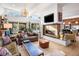 Open-concept living area with fireplace, large windows, and stylish furnishings at 317 Seewee Cir, Mount Pleasant, SC 29464
