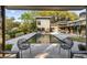 Beautiful backyard featuring a modern pool, covered patio, and lush landscaping for a relaxing outdoor experience at 317 Seewee Cir, Mount Pleasant, SC 29464