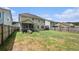 Spacious backyard with green grass, a screened-in porch, and privacy fencing at 317 Whispering Breeze Ln, Summerville, SC 29486