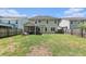 Large grassy backyard with a screened-in porch and privacy fence, perfect for outdoor entertaining at 317 Whispering Breeze Ln, Summerville, SC 29486