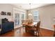 Cozy dining area featuring hardwood floors, a wooden table, and access to the outdoor space through glass doors at 317 Whispering Breeze Ln, Summerville, SC 29486