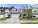 Charming two-story home with a well-maintained lawn, a two-car garage, and a cozy front porch at 317 Whispering Breeze Ln, Summerville, SC 29486