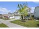 Inviting two-story home featuring a well-manicured lawn and a welcoming front porch with seating at 317 Whispering Breeze Ln, Summerville, SC 29486