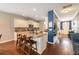 Spacious kitchen with a large island, granite countertops, white cabinets, and an open layout to the hallway at 317 Whispering Breeze Ln, Summerville, SC 29486