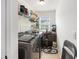 Functional laundry room featuring modern washer and dryer units, storage shelves, and ample space at 317 Whispering Breeze Ln, Summerville, SC 29486
