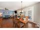 Open-concept living and dining area with hardwood floors, natural light, and cozy furniture at 317 Whispering Breeze Ln, Summerville, SC 29486