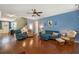 Comfortable living room with stylish blue walls, hardwood floors, and an array of seating options at 317 Whispering Breeze Ln, Summerville, SC 29486
