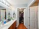 Bathroom featuring a vanity with a large mirror and a view into a closet at 325 Dupont Way, Summerville, SC 29485