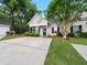 Charming home showcasing a well-maintained front yard, driveway and detached garage at 325 Dupont Way, Summerville, SC 29485
