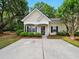 Charming single-story home with a cozy front porch and well-manicured landscaping at 325 Dupont Way, Summerville, SC 29485