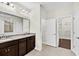 Bathroom with dual sink vanity, granite countertops, large mirror and doorway leading to walk-in closet at 3321 Tabard Rd, Johns Island, SC 29455