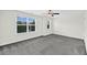 Bright bedroom with large window, ceiling fan, and plush gray carpeting at 3321 Tabard Rd, Johns Island, SC 29455