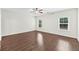 A spacious bedroom with wood floors, a ceiling fan, and two windows providing natural light at 3321 Tabard Rd, Johns Island, SC 29455