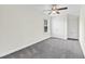 Neutral bedroom with large window, ceiling fan, closet, and soft carpeting at 3321 Tabard Rd, Johns Island, SC 29455