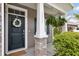 A welcoming entryway with a decorative wreath and hanging fern at 3321 Tabard Rd, Johns Island, SC 29455