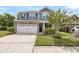 Charming two-story home featuring stone accents, a two-car garage, and a well-maintained lawn at 3321 Tabard Rd, Johns Island, SC 29455