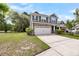 Two-story home with stone accents, a two-car garage, and a well-maintained front lawn at 3321 Tabard Rd, Johns Island, SC 29455