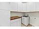 Laundry room with white cabinets, butcher block countertop, utility sink, and washer/dryer hookups at 3321 Tabard Rd, Johns Island, SC 29455