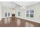 A spacious living room featuring hardwood floors, a fireplace, and lots of natural light at 3321 Tabard Rd, Johns Island, SC 29455