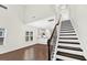 Living room with hardwood floors, staircase, view to kitchen, and a window with lots of natural light at 3321 Tabard Rd, Johns Island, SC 29455