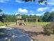 Community playground with a wooden lighthouse, slide, and swings under a blue sky at 3321 Tabard Rd, Johns Island, SC 29455