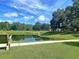 Scenic pond with playground and blue sky, adjacent grassy park with walking path at 3321 Tabard Rd, Johns Island, SC 29455