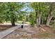 Peaceful pond with path, black waste receptacle, and a wooded area in the background at 3321 Tabard Rd, Johns Island, SC 29455