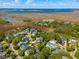 Expansive aerial view capturing a neighborhood with waterways and lush greenery under a blue sky at 337 Evian Way, Mount Pleasant, SC 29464