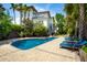 Lush backyard with a sparkling pool, lounge chairs, and mature landscaping, offering a private retreat at 337 Evian Way, Mount Pleasant, SC 29464