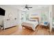 Bright bedroom with a wooden bed frame, ceiling fan, light-colored walls, and access to a balcony at 337 Evian Way, Mount Pleasant, SC 29464