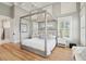 Bright main bedroom with four-poster bed, tray ceiling, hardwood floors, and plantation shutters at 337 Evian Way, Mount Pleasant, SC 29464