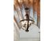 Attractive, orb-shaped, wrought iron chandelier with candelabra lights against a wooden plank ceiling at 337 Evian Way, Mount Pleasant, SC 29464